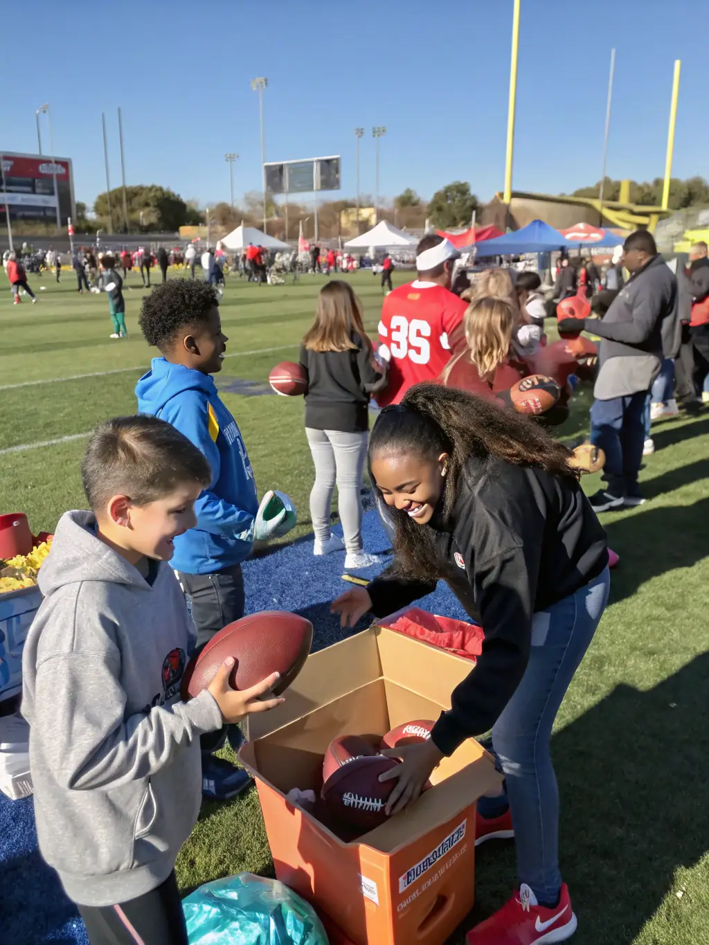 Volunteers setting up equipment for a rugby event, demonstrating community involvement and support for LES AMIS DE L'OVALE's activities.